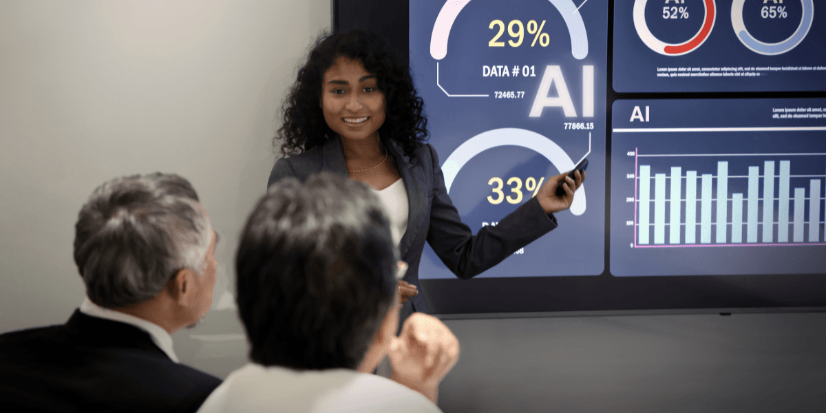 Businesswoman presenting data insights on a digital screen to two viewers in a meeting