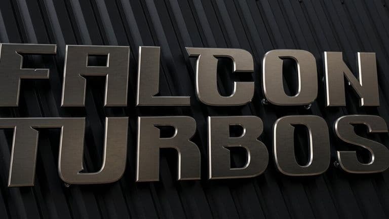 Metallic Falcon Turbos logo mounted on black textured wall background.