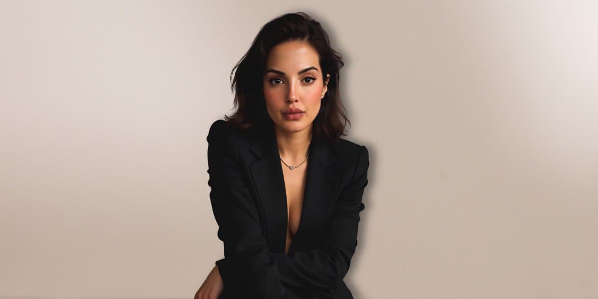 Author Seema Tangri seated in a black blazer against a neutral background, promoting openness, resilience, and relationship communication.
