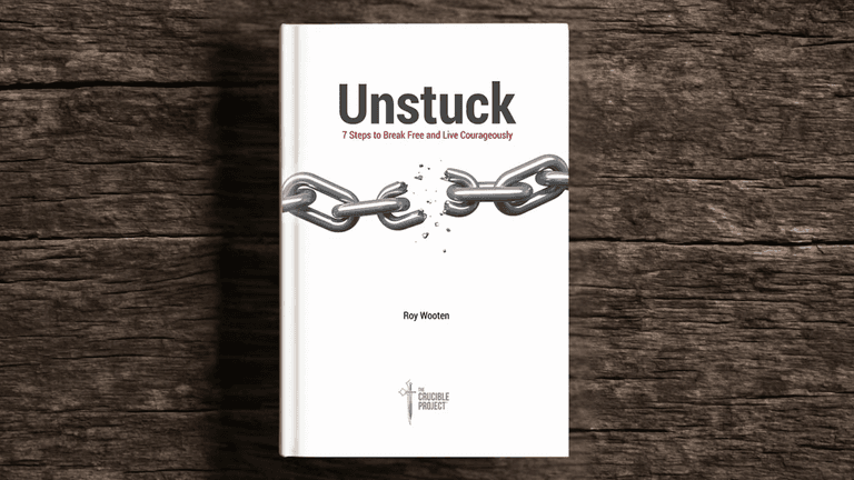 "Book cover of 'Unstuck' by Roy Wooten, featuring broken chains symbolizing personal growth and leadership transformation."