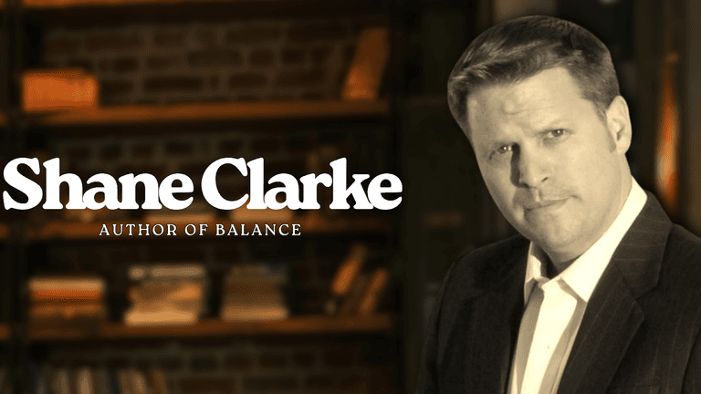 Shane Clarke, author of Balance, stands confidently in a library setting promoting his personal freedom philosophy.