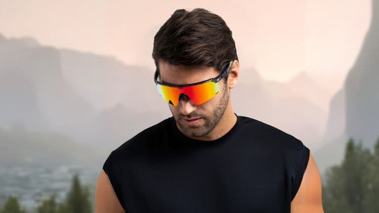 Man wearing BEXST sunglasses, embodying adventure and performance, against a rugged mountain backdrop.