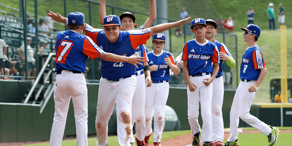 Group of young baseball players celebrating a win on the field