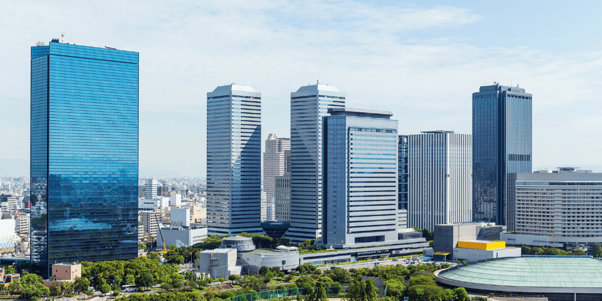 Modern cityscape featuring tall skyscrapers and a clear blue sky