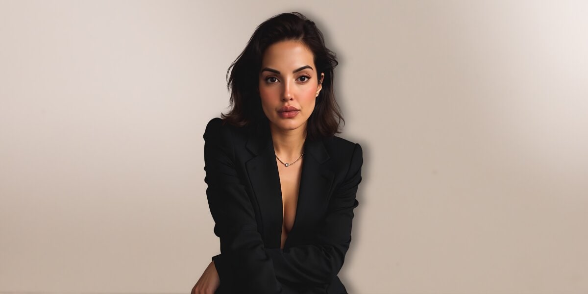 Author Seema Tangri seated in a black blazer against a neutral background, promoting openness, resilience, and relationship communication.