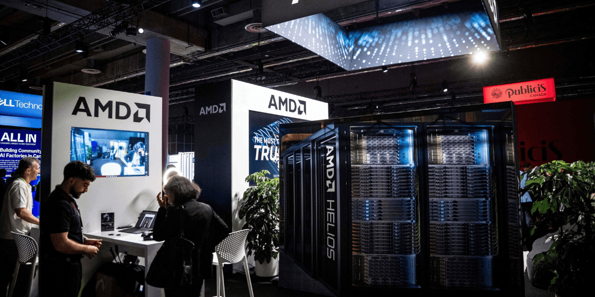 AMD booth at tech event featuring displays, servers, and attendees engaging with technology