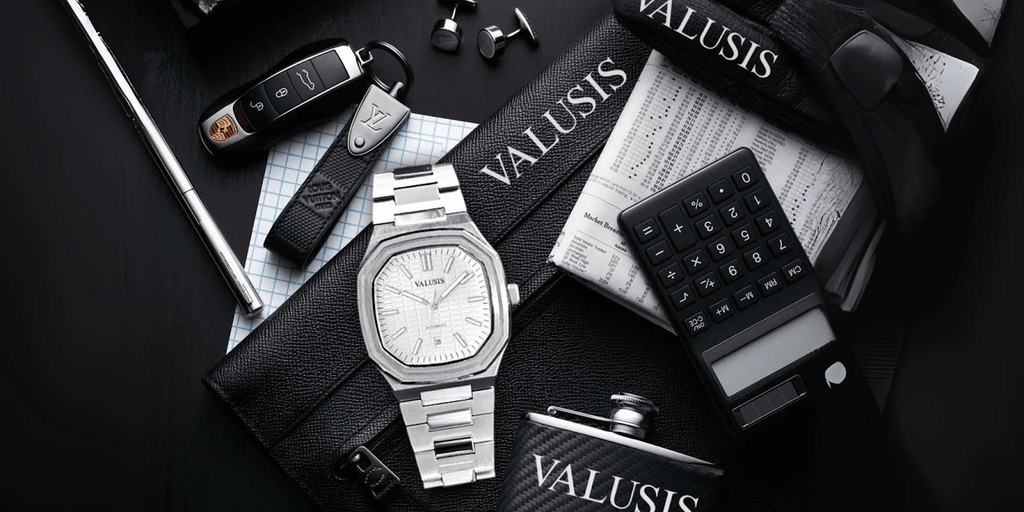 An image featuring a luxury setup with a Valusis watch placed alongside premium items like a Porsche key, Louis Vuitton wallet, and a calculator, emphasizing sophistication and elegance.
