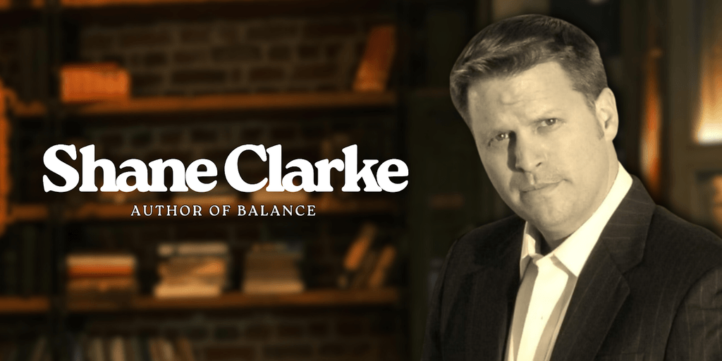 Shane Clarke, author of Balance, stands confidently in a library setting promoting his personal freedom philosophy.