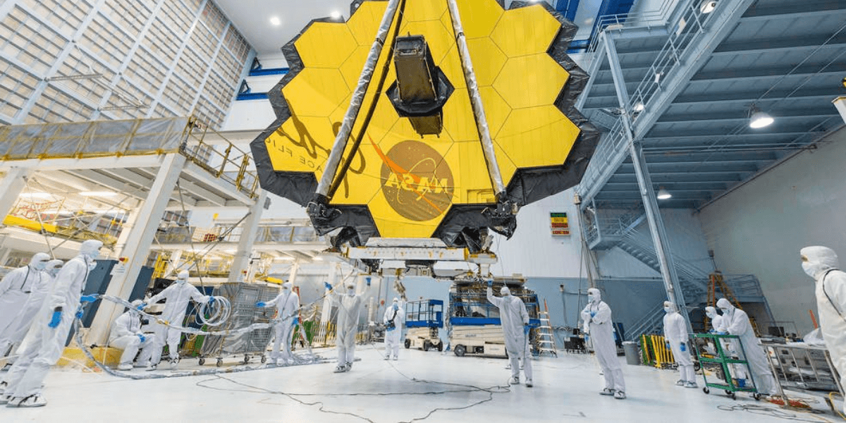 NASA technicians working on the large, hexagonal, gold-coated James Webb Space Telescope