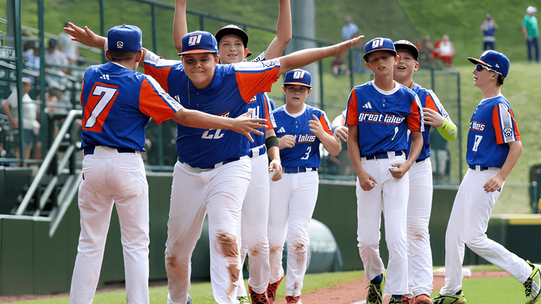 Group of young baseball players celebrating a win on the field