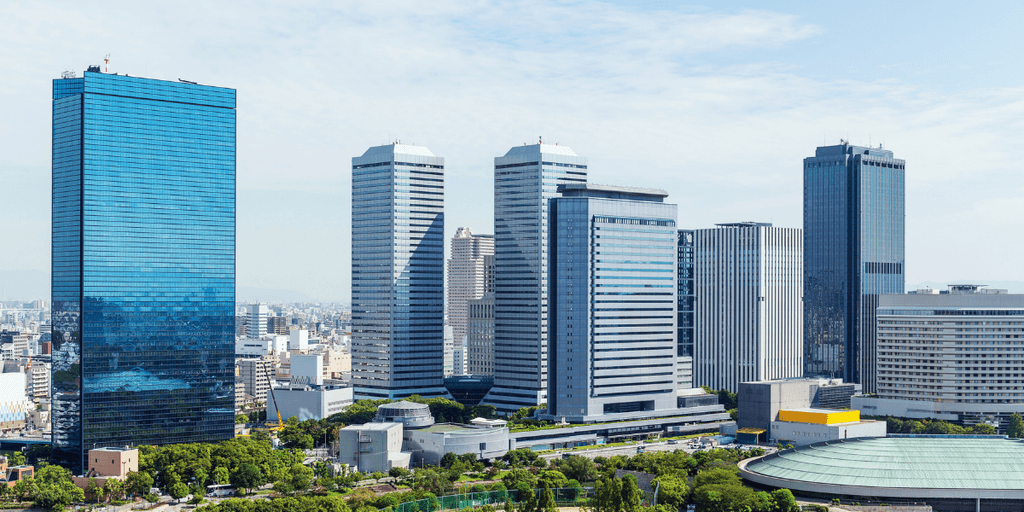 Modern cityscape featuring tall skyscrapers and a clear blue sky