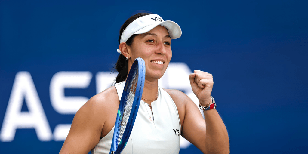 Tennis player celebrating a victory, holding her racket and smiling confidently