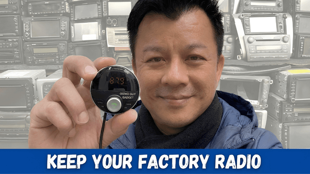 Person holding a gadget for factory radio conversion with vintage radios in background