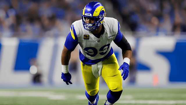 NFL player in blue and yellow uniform poised for action on the field