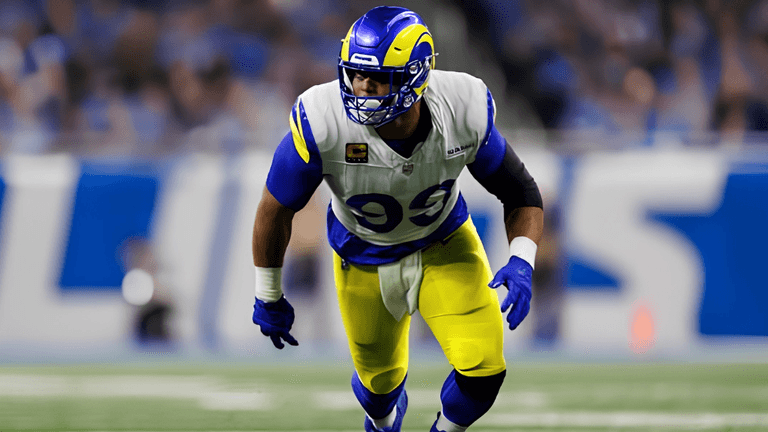 NFL player in blue and yellow uniform poised for action on the field