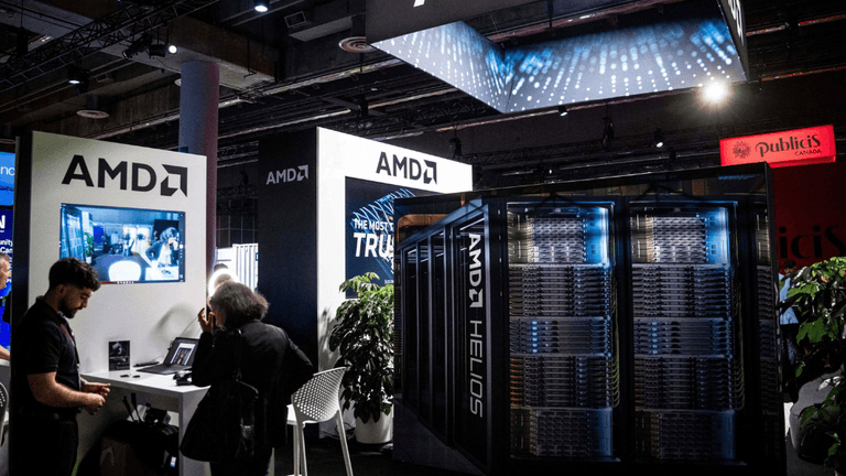AMD booth at tech event featuring displays, servers, and attendees engaging with technology
