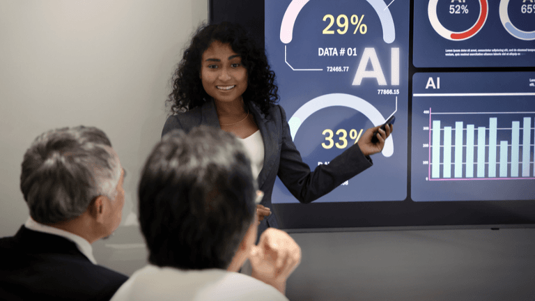 Businesswoman presenting data insights on a digital screen to two viewers in a meeting