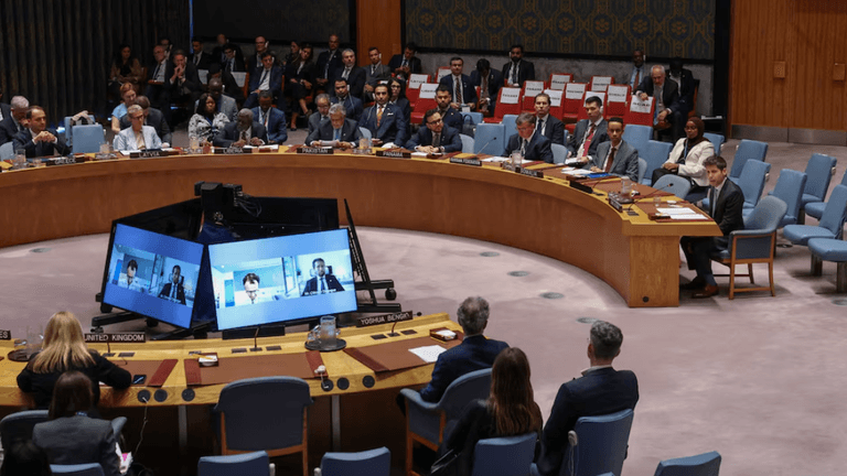 United Nations Security Council meeting with delegates seated around a circular table