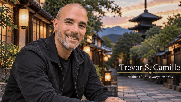 Smiling man in a black jacket sitting outdoors in a picturesque setting at dusk