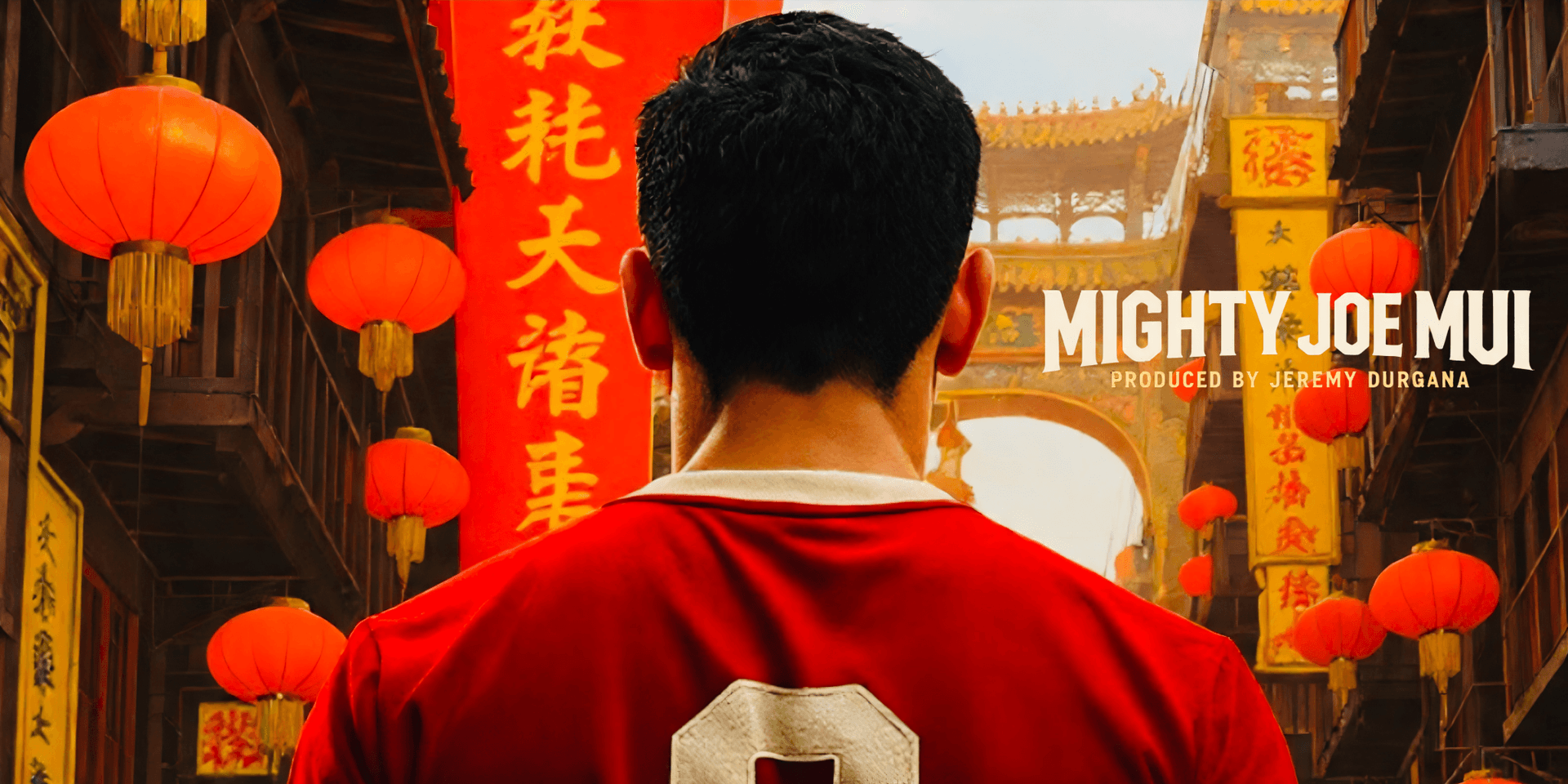A man in a red jersey stands in a vibrant street decorated with lanterns.