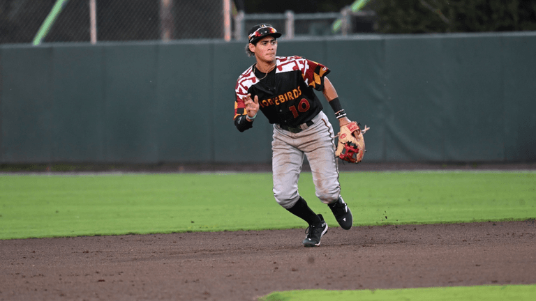 Player in Shorebirds uniform running on the infield.
