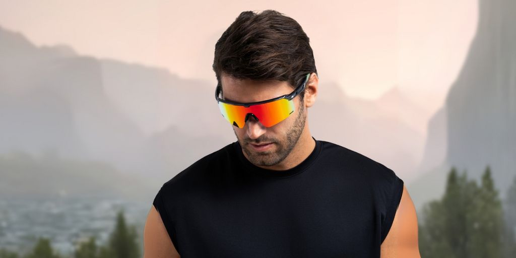 Man wearing BEXST sunglasses, embodying adventure and performance, against a rugged mountain backdrop.
