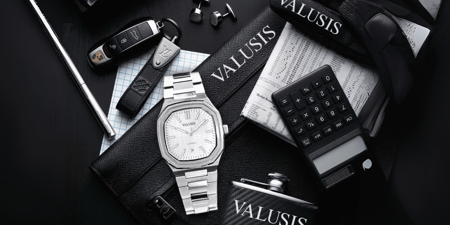 An image featuring a luxury setup with a Valusis watch placed alongside premium items like a Porsche key, Louis Vuitton wallet, and a calculator, emphasizing sophistication and elegance.