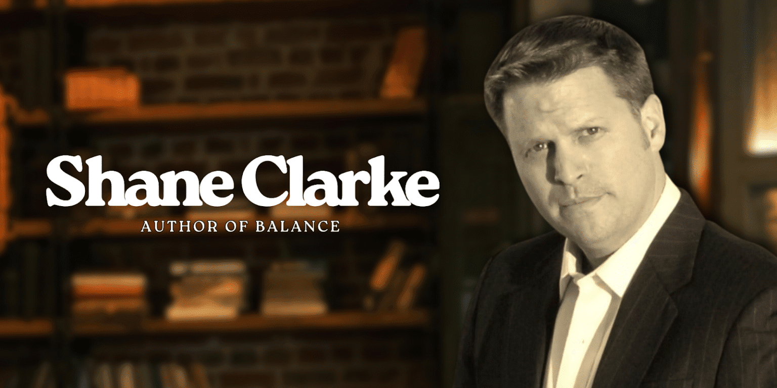 Shane Clarke, author of Balance, stands confidently in a library setting promoting his personal freedom philosophy.