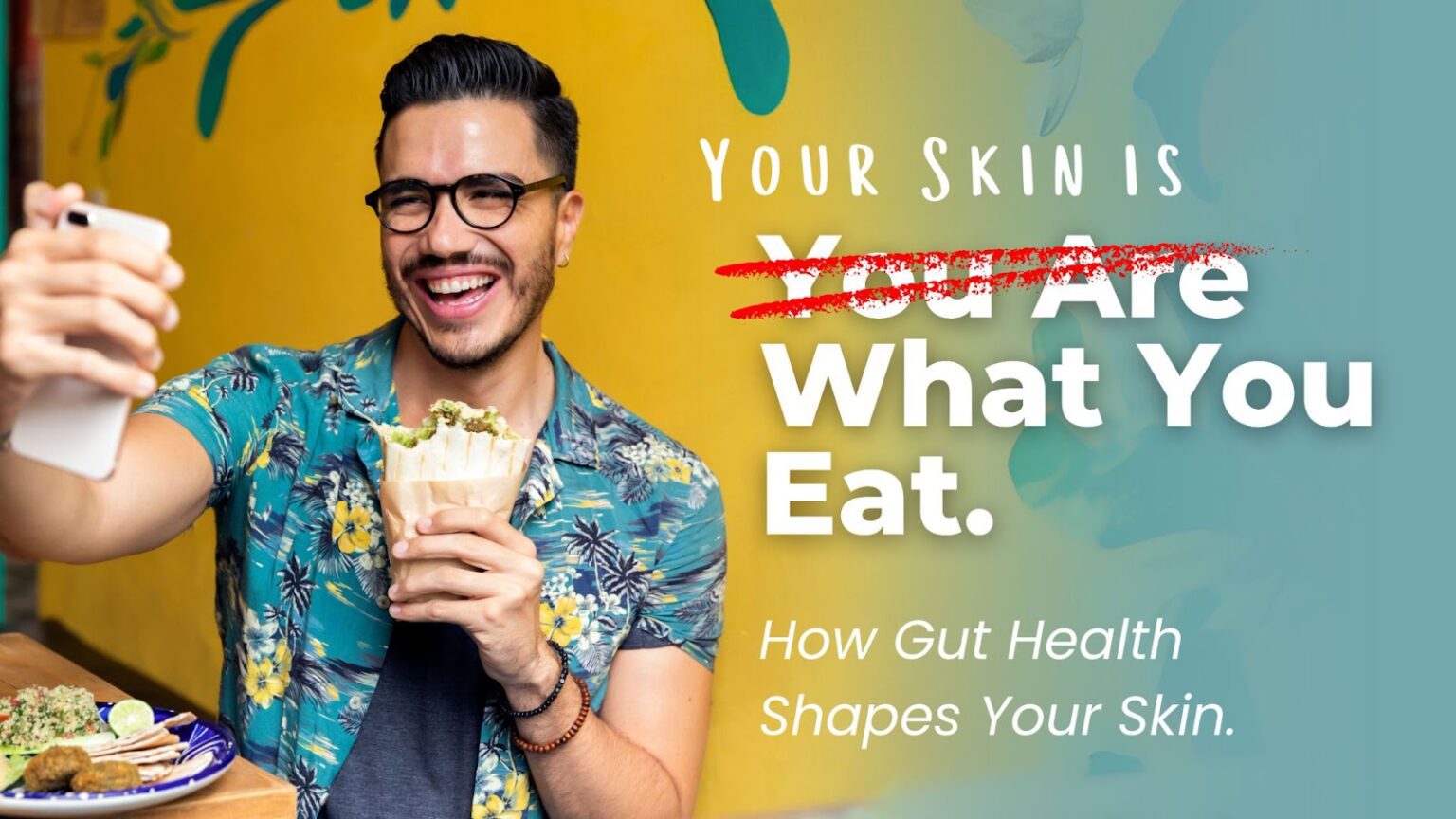 Man smiling and taking a selfie while holding a healthy wrap, surrounded by a vibrant background with a plate of food on the table. Text overlay reads 'Your Skin is What You Eat. How Gut Health Shapes Your Skin.' emphasizing the connection between gut health and skin.